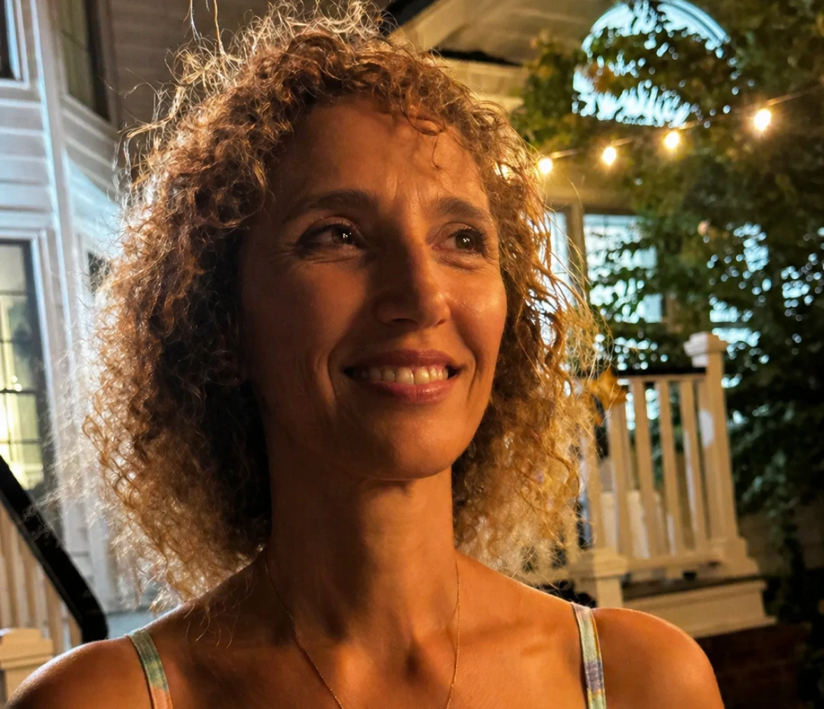 Evening portrait of woman near house